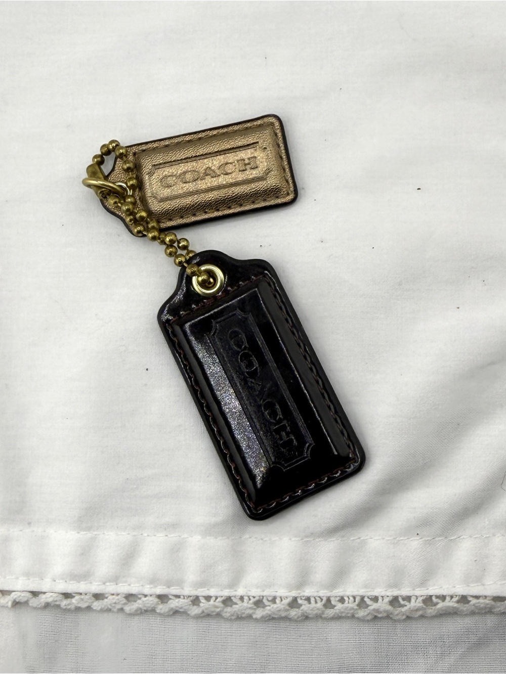 Coach purse tags. Maroon and gold.